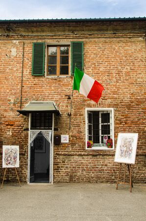 Brick wall of painting shop with Italian flagの写真素材