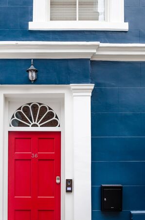 Blue wall with red door of a London houseの写真素材