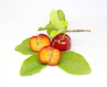 Fresh acerola fruit and slice isolated on whiteの写真素材