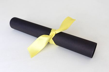 Black paper with yellow ribbonの写真素材