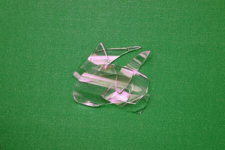 Pieces of glasses isolated on green background