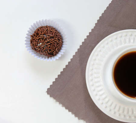 Sweet brigadeiro with coffee on the table