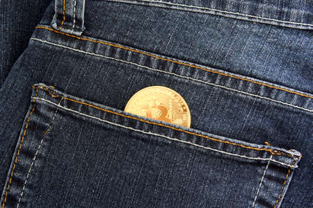 Recife, Pernambuco, Brazil - October 18, 2021: Bitcoin golden coin in pants pocket. Cryptocurrency concept as a form of payment.のeditorial素材