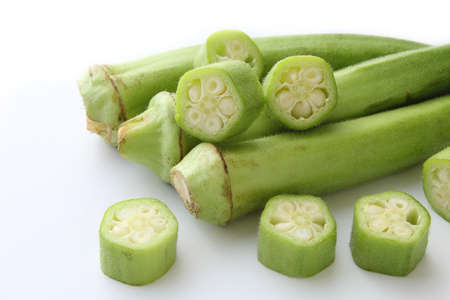 Raw green okra sliced â€‹â€‹on white background