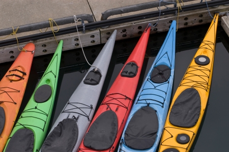 Several colorful kayaks tied at dock in Alaskaの写真素材
