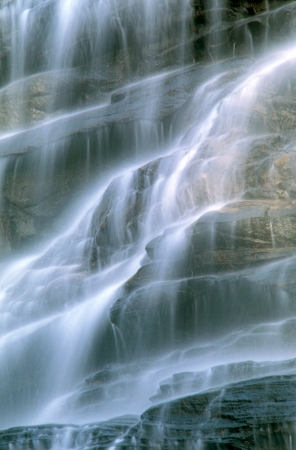 Close detail of a cascade as it flows down rocksの写真素材