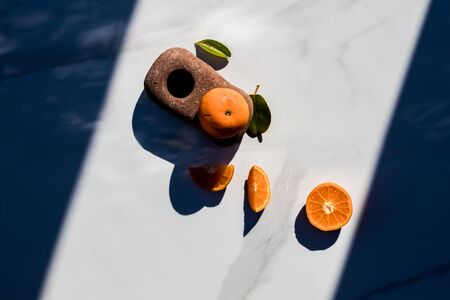 sliced mandarines on a white boardの写真素材