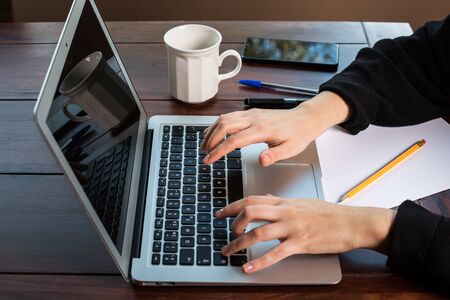 hands using the keyboard of a laptop