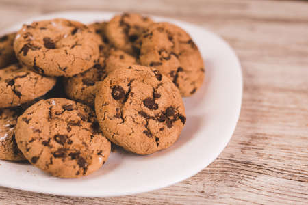 some chocolate cookies on a white plateの写真素材
