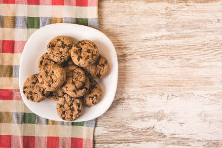 some chocolate cookies on a white plateの写真素材