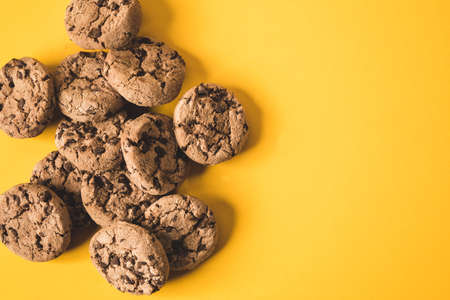 some chocolate cookies on a yellow backgroundの写真素材