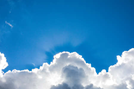 A blue sky background with cloudsの写真素材