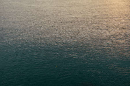 sunset light reflected over waterの写真素材