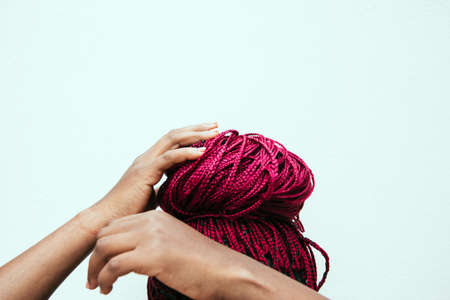 red braids with a colorful background