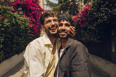 Portrait of two men in the city. Smiling and laughing.の写真素材