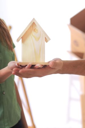 young couple and little home in the handsの写真素材