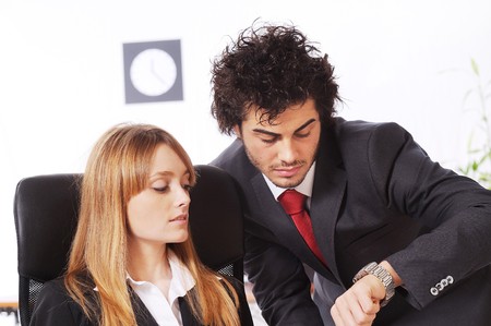 worker couple look the watch in the office