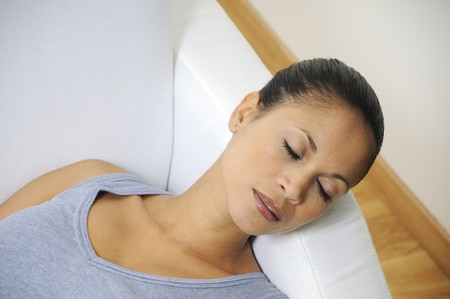 beautiful woman sleep on the white sofaの写真素材