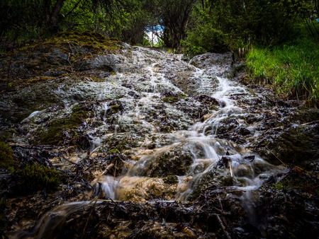 water flows down moss hillの写真素材