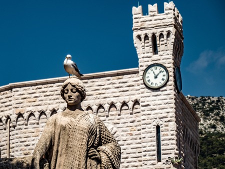 small seagull standing on a sculptureの写真素材