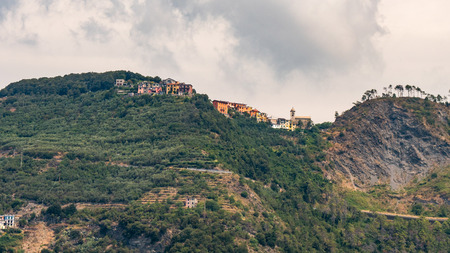 little village on steep hill in italy coastの写真素材