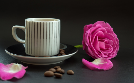 coffee with pink rose on dark leather surface with coffee beansの写真素材