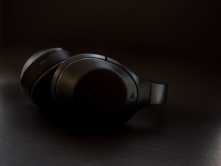 Over Ear Headphones on dark leather surface close upの写真素材