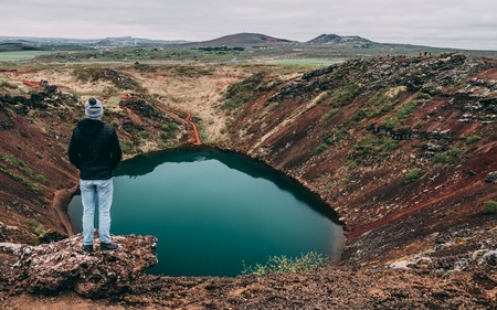 guy watching down to the Kreio crater lake