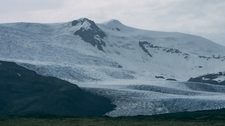 glacier in iceland on a mountain covered in cloudsの写真素材
