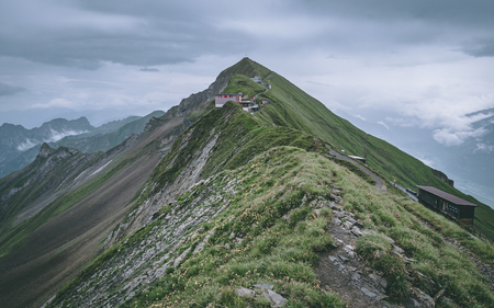 mountain hut on the top of a mountain in the swiss alps brienzer rothorn hohenweg switzerland cloudyの写真素材