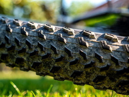 close up of dirty mountain bike wheel profile with dirt and natrual background