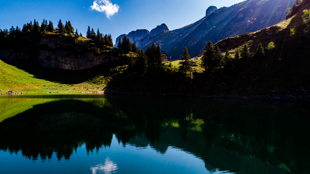 aerial view of deep blue mountain lake in swiss alps with house, switzerland alpsteinの写真素材