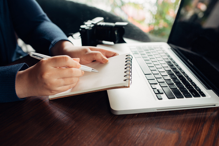 Woman hands working with a laptop in a coffee shopの写真素材