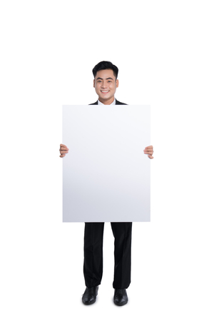 Happy young man showing and displaying placardの写真素材