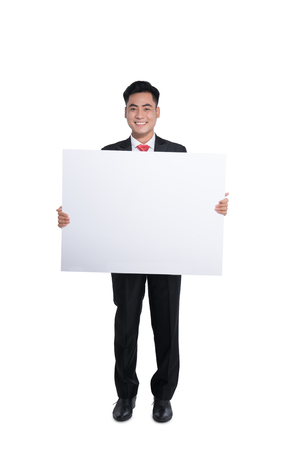 Happy young man showing and displaying placardの写真素材