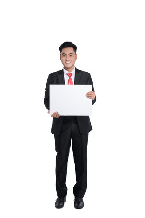 Happy young man showing and displaying placardの写真素材