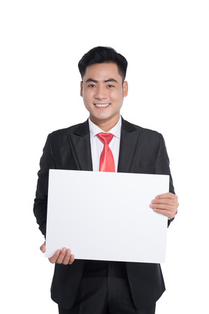 Happy young man showing and displaying placardの写真素材