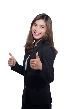Happy businesswoman showing thumb up over white background.の写真素材