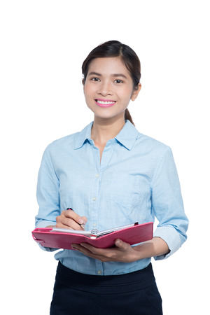 Vietnamese Businesswoman take note on notebookの写真素材
