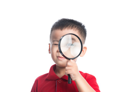 Portrait asian child looking through magnifying loupeの写真素材