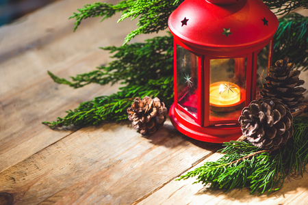 Red Christmas lantern with candle on  wooden backgroundの写真素材