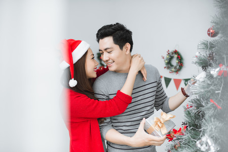 Christmas Asian Couple.Happy Smiling Family at home celebrating.New Year Peopleの写真素材