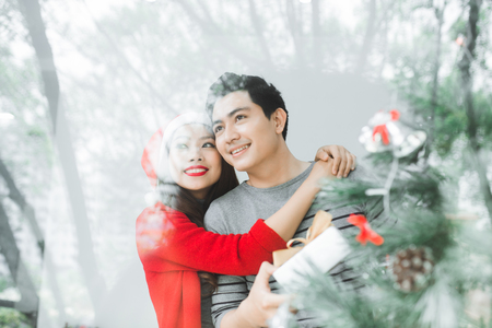 Christmas Asian Couple.Happy Smiling Family at home celebrating.New Year Peopleの写真素材