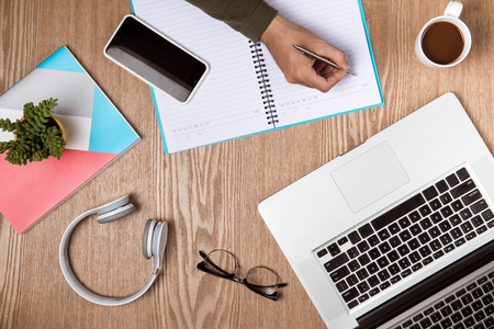 Business man hands using a laptop with a cup of coffee and smart phone with copy space.の写真素材
