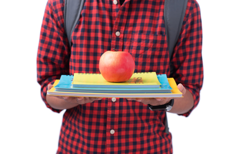 Hands holding red apple with book, isolated on white.の写真素材