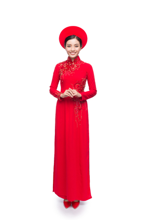 Full length of Vietnamese Bride in Red Ao Dai Traditional Dress with hat.の写真素材