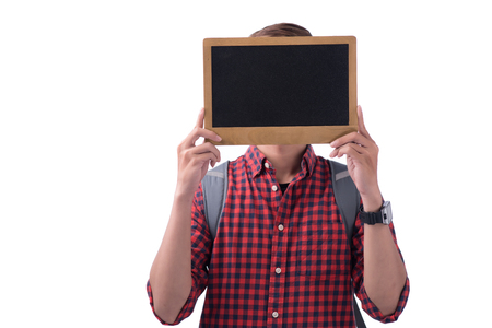Asian male student covering his face with a chalkboardの写真素材