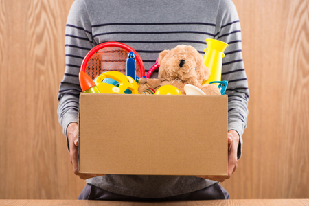 Male volunteer holding donation box with old toys.の写真素材