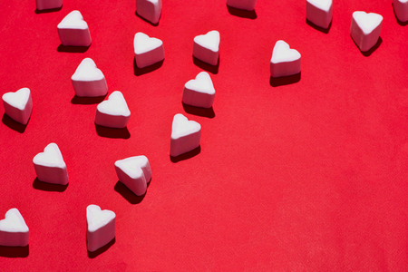 Valentines Day candy hearts marshmallows over red backgroundの写真素材