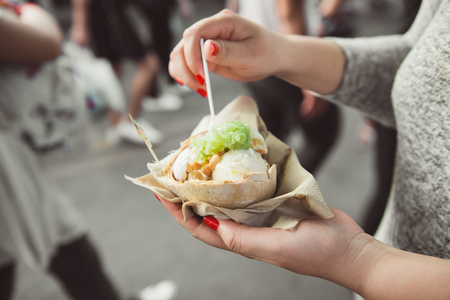 Woman hands holding ice cream on coconutの写真素材